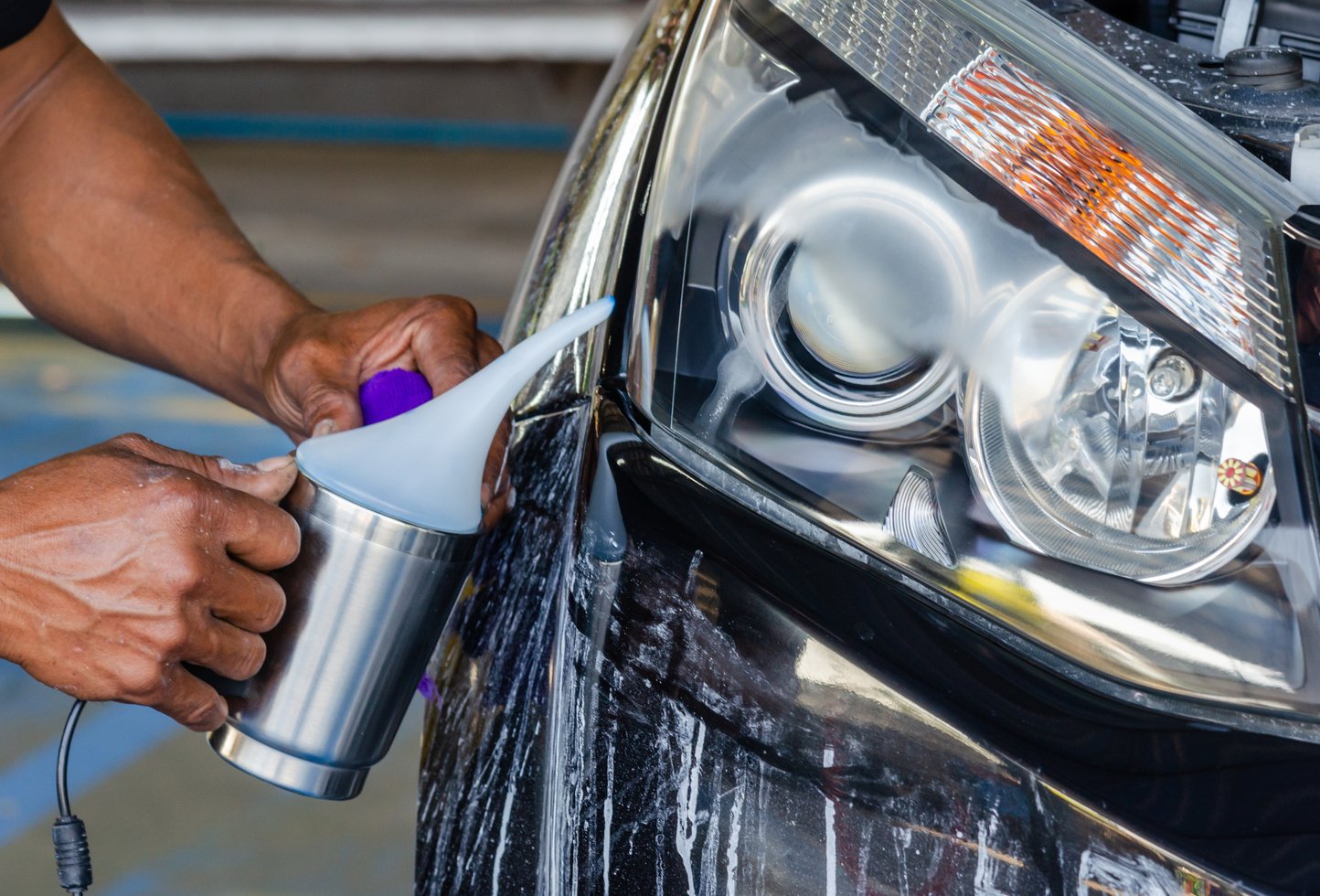 Person Polishing Car Headlights